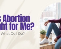 Young woman in a maroon sweater sitting at a window with a phone nearby — thinking about whether abortion is the right choice in Detroit.
