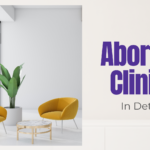 Woman standing in a modern office-style space — considering abortion clinics in Detroit and where to turn for trusted advice.