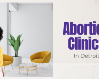 Woman standing in a modern office-style space — considering abortion clinics in Detroit and where to turn for trusted advice.