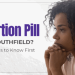 Woman looking thoughtful while considering options for abortion pill in Southfield, Michigan