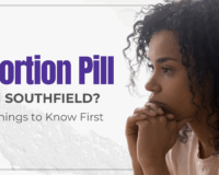 Woman looking thoughtful while considering options for abortion pill in Southfield, Michigan