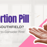 Abortion pill in Southfield. Close-up of medication tablets in woman's hand next to article title.